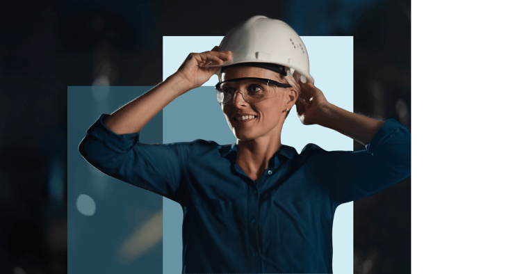 woman puts a hard hat on with safety glasses