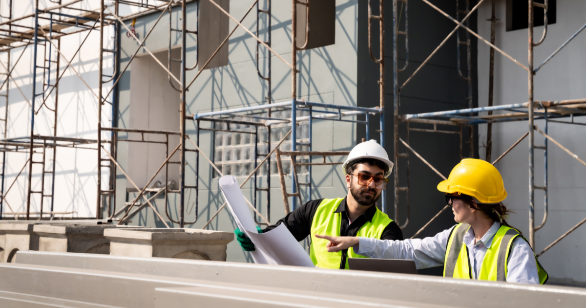construction workers looking over plan at construction site