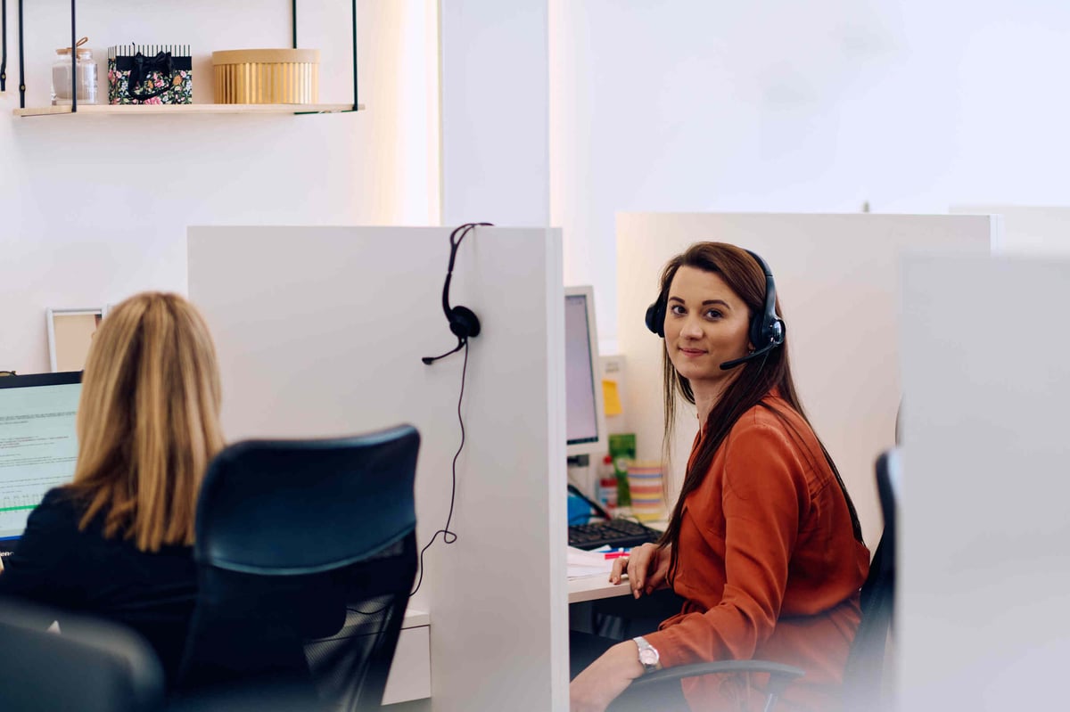 ACA support person on a call in her office