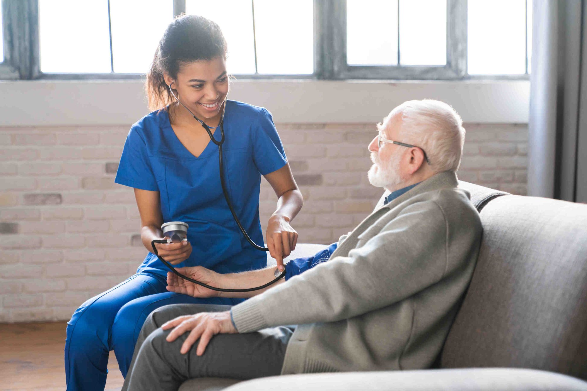 Home healthcare woman helping elderly man