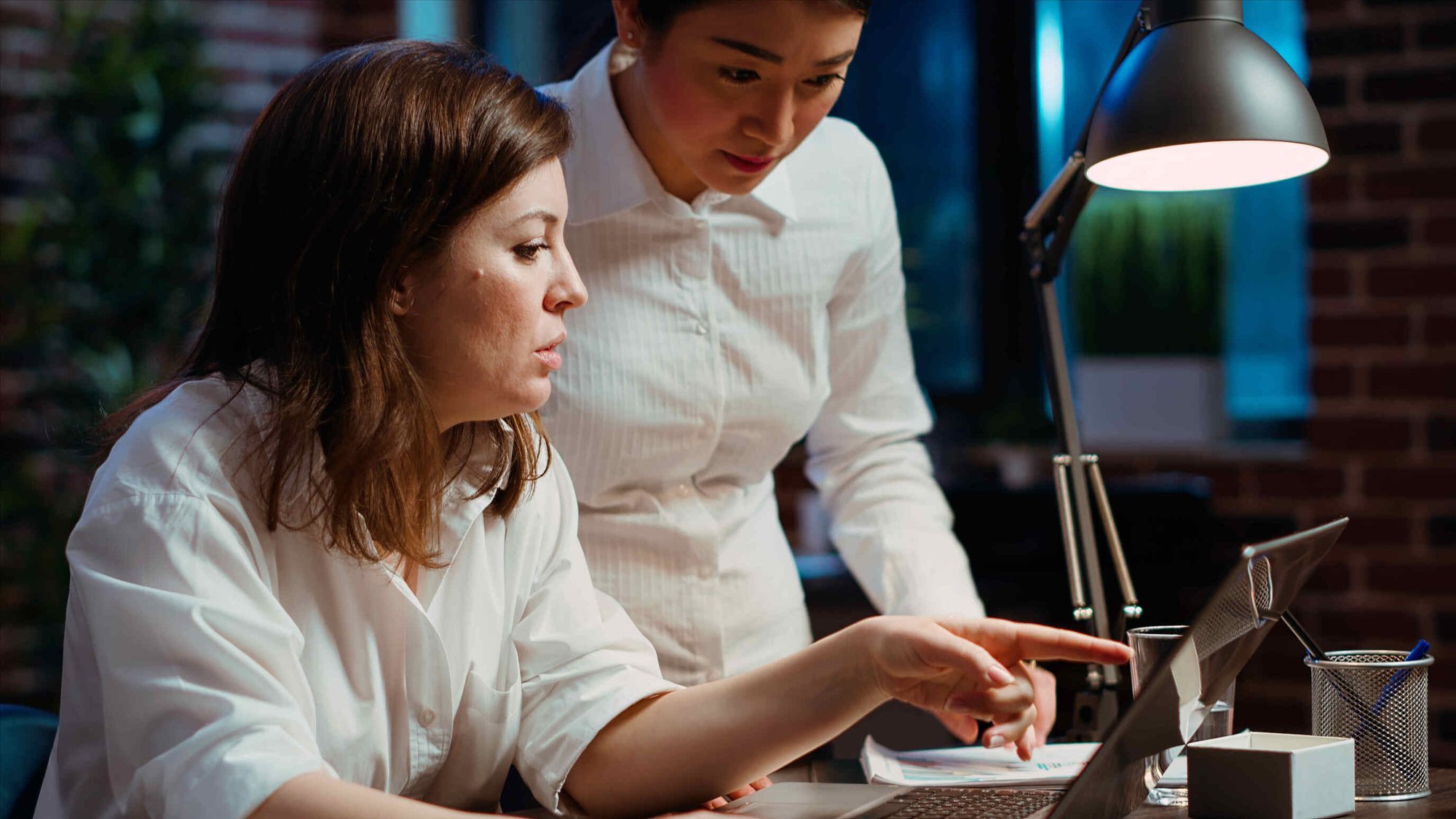 Worker collaborating with team member on compliance