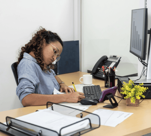 decorative image of a woman in her office focused