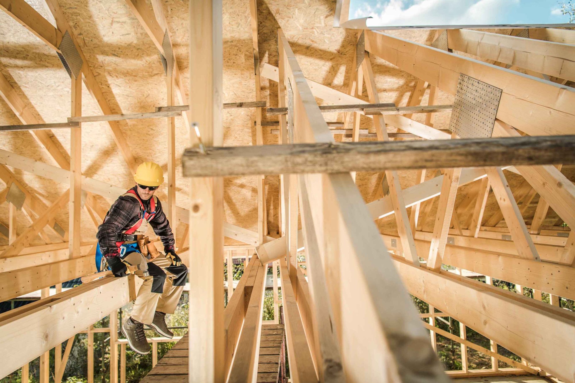 Construction Worker Sitting on Wooden Beam On Construction Site