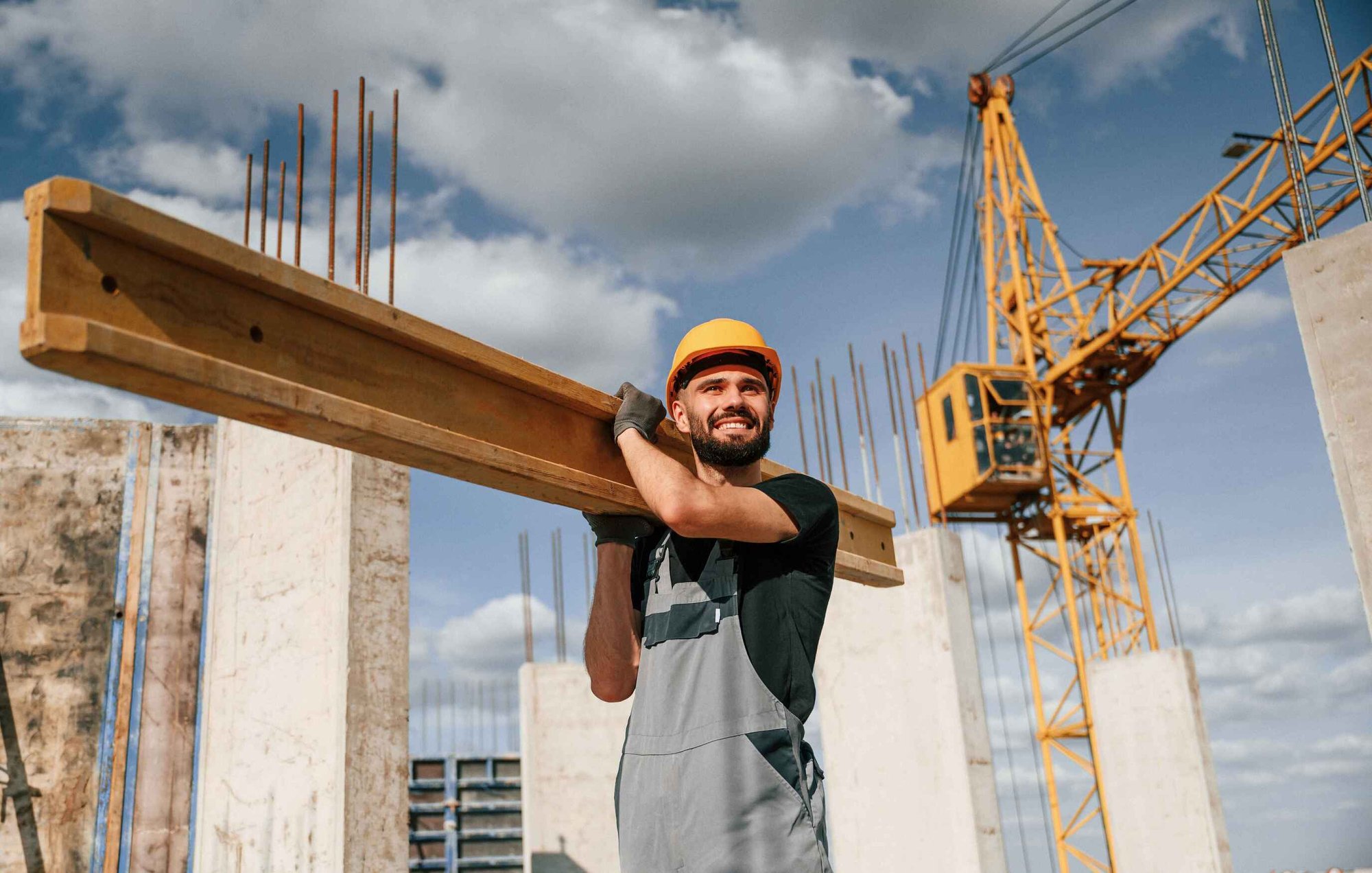 Construction Worker Holding Materials On Building Site