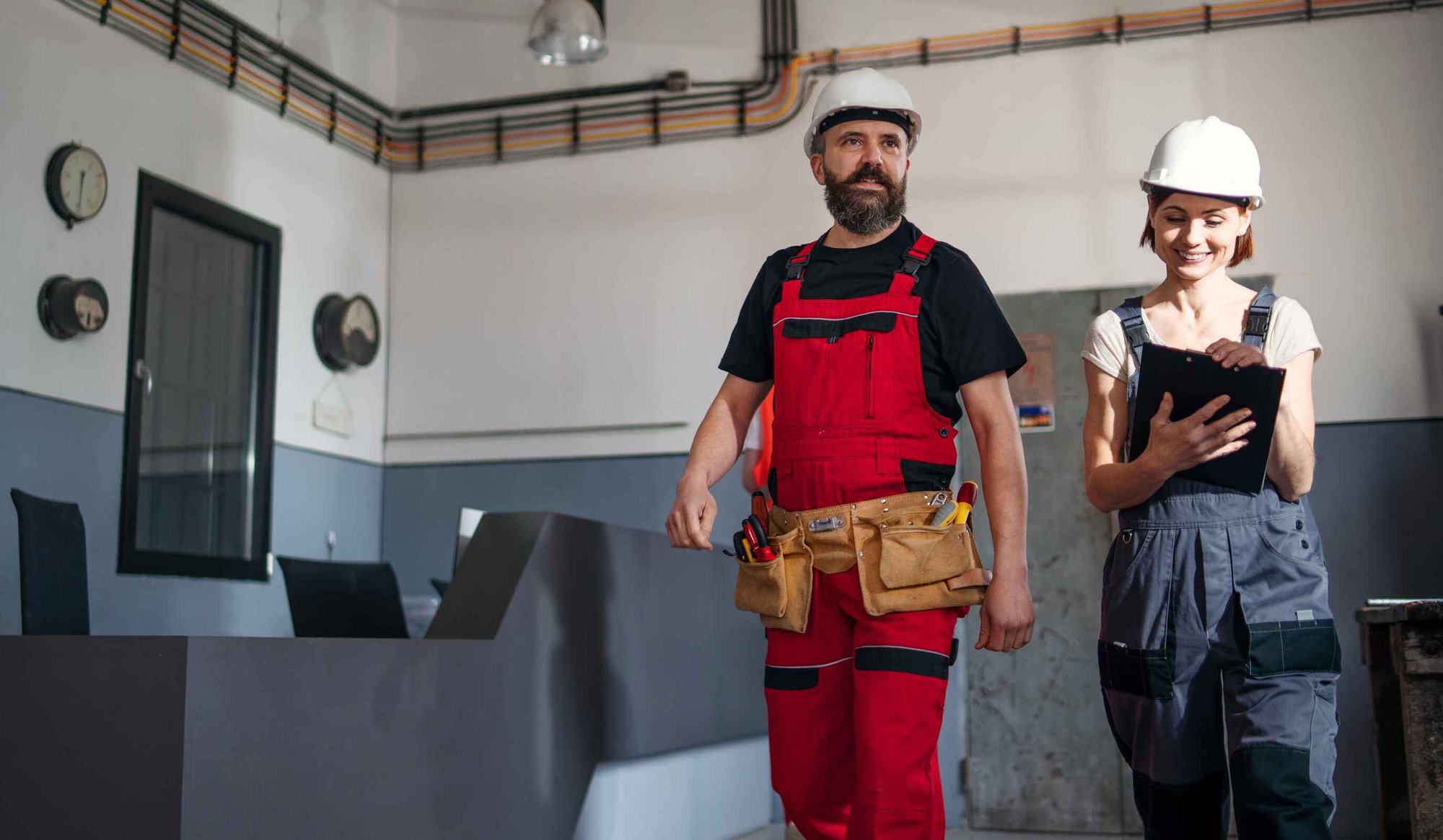 Man and Woman Construction Workers Surveying Site