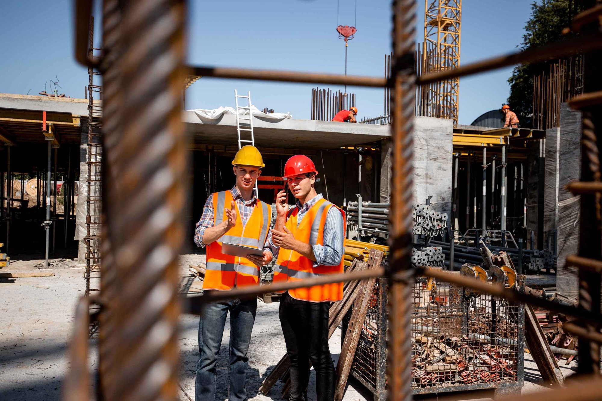 Contractors in Orange Work Vests on Worksite