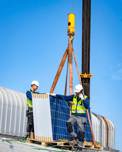 decorative: Two workers putting in solar panels