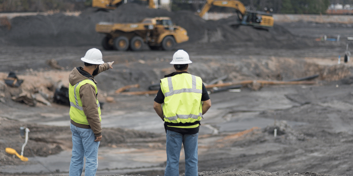 decorative: two men on a bridge construction site looking at progress decorative: two men on a bridge construction site looking at progress