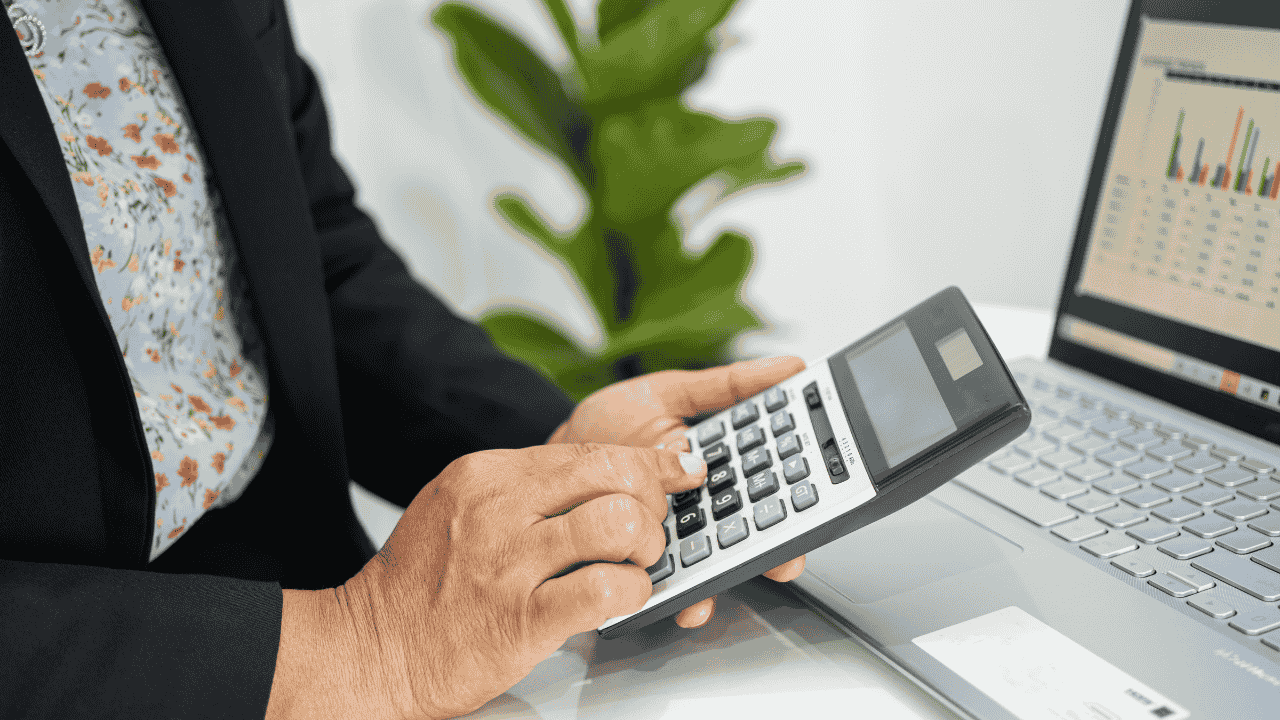 Woman holds calculator in office