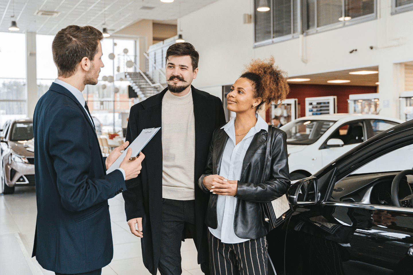 Couple Speaking With a Car Dealership Salesman