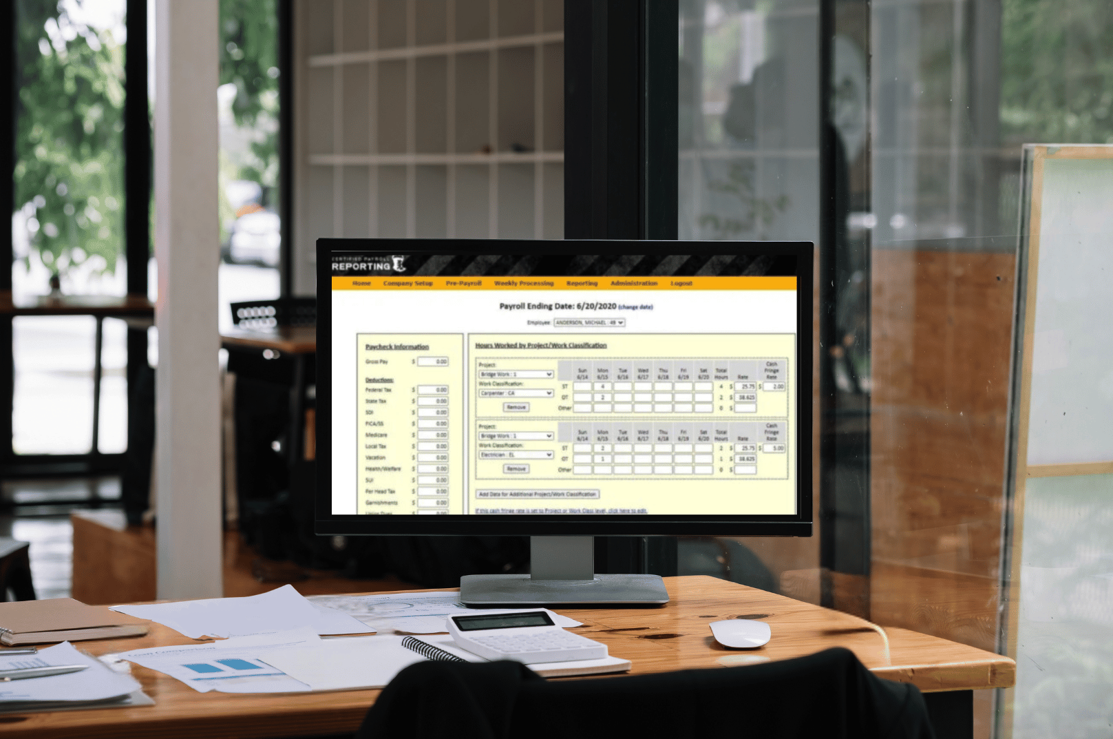 Points North's certified payroll reporting on screen in office