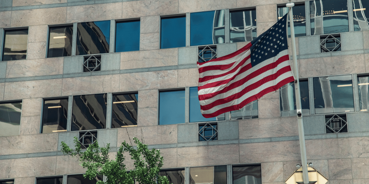 United States flag flys outside of building