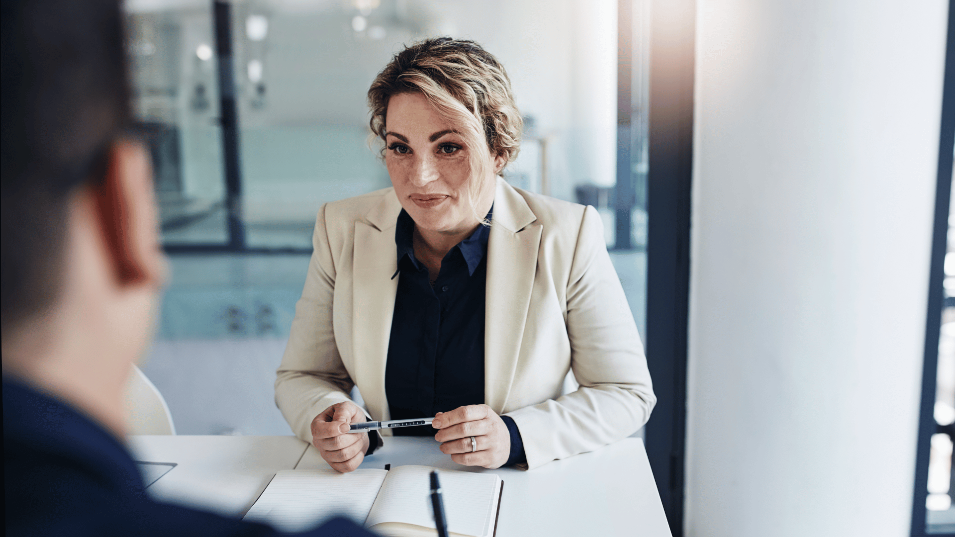 hr professional talking with an employee in her office