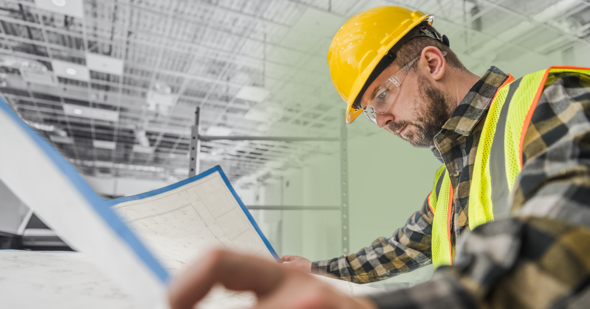 Foreman looking at blueprints on a construction site