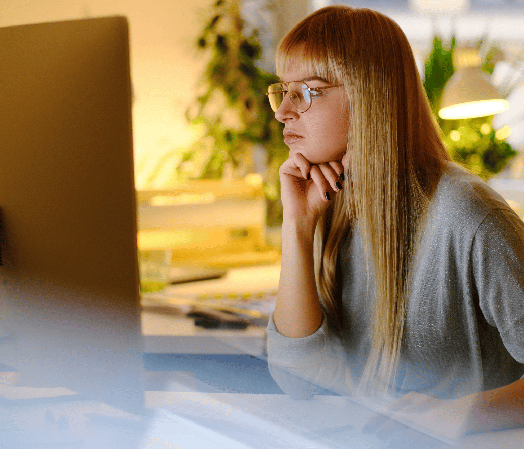 female worker focused on her desktop computer in office
