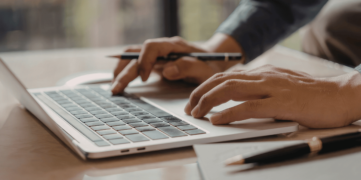 decorative. Hands typing on a laptop