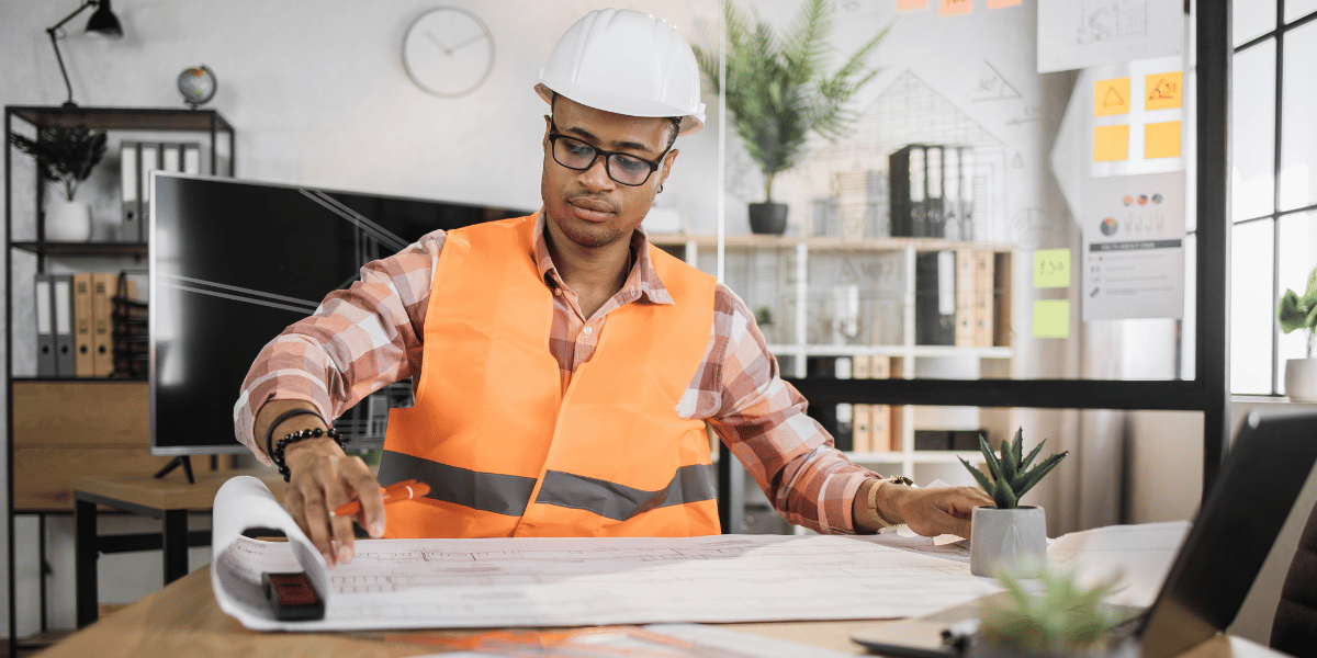 Person reviewing construction plans.