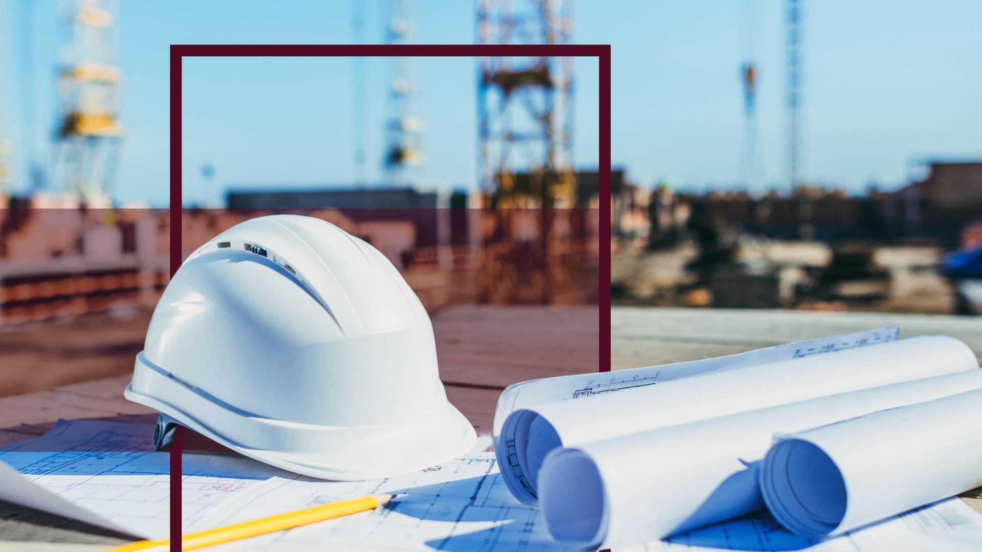 hardhat and construction blueprints at a construction site