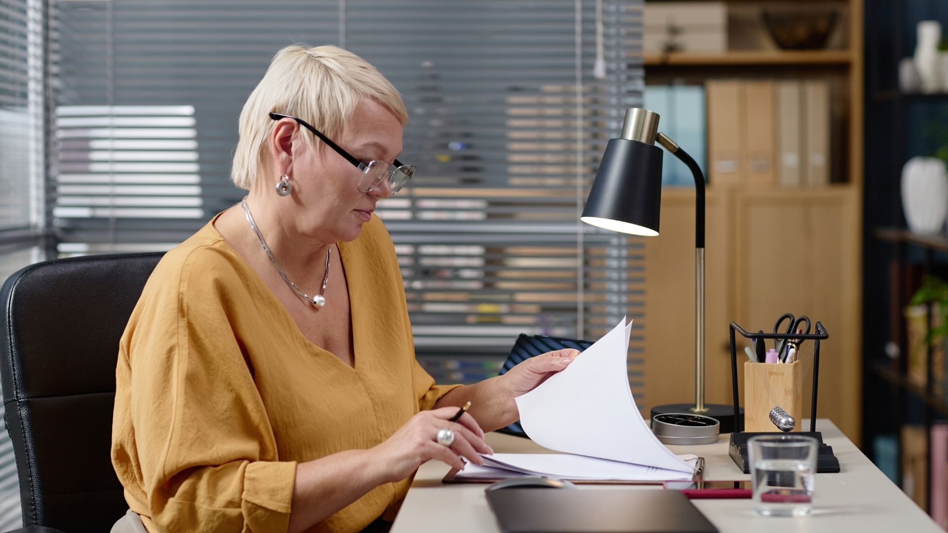 an HR professional looks over documents in her office an HR professional looks over documents in her office