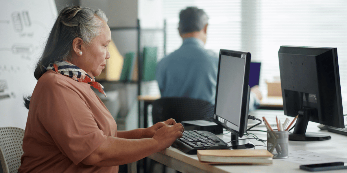 Decorative: Woman employee in office in Maryland working on certified payroll Decorative: Woman employee in office in Maryland working on certified payroll