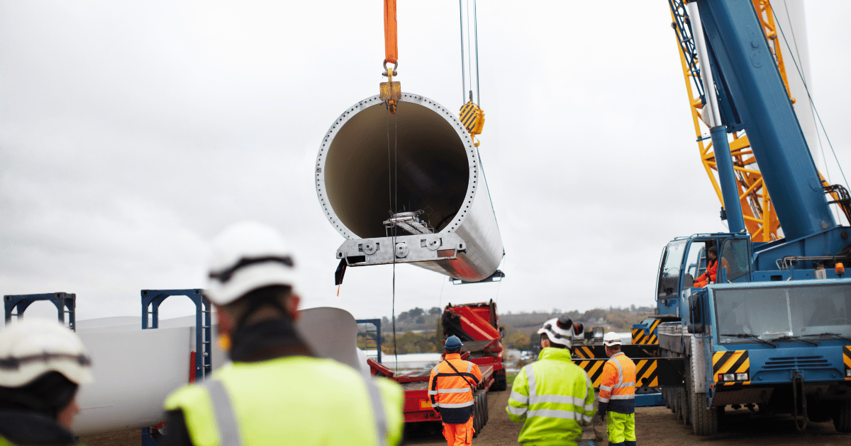 engineers install a wind turbine