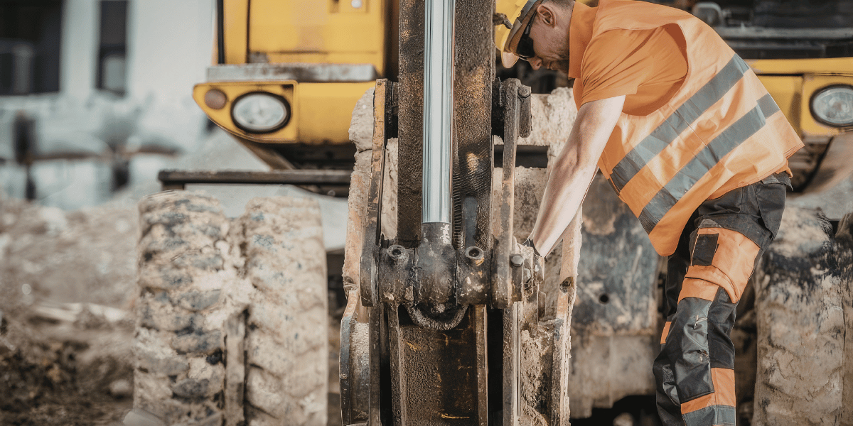 decorative: man working on heavy construction machinery decorative: man working on heavy construction machinery